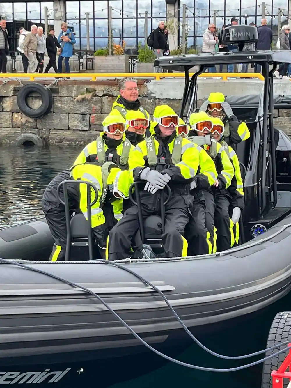 Group of children in safety gear in rigid inflatable boat