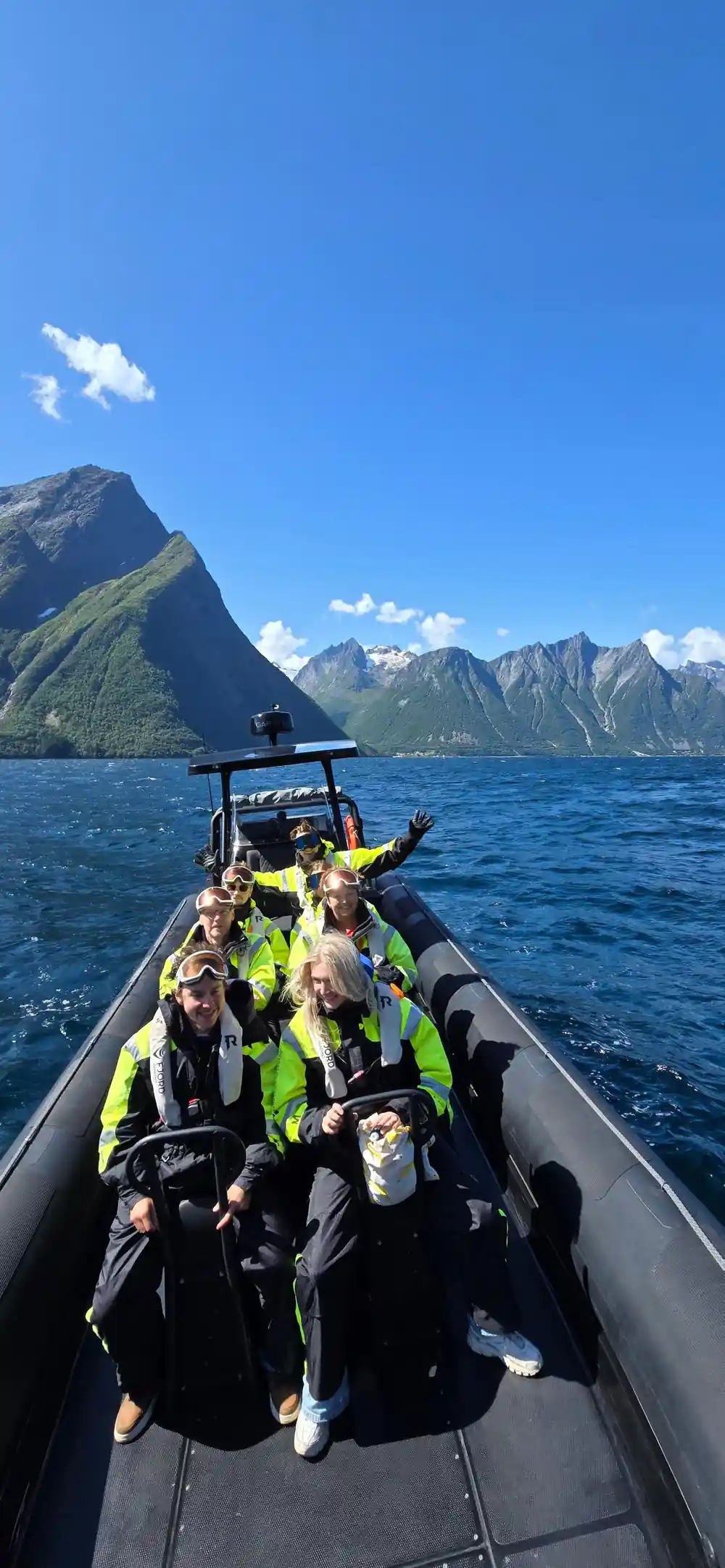 Group of people in speedboat on water
