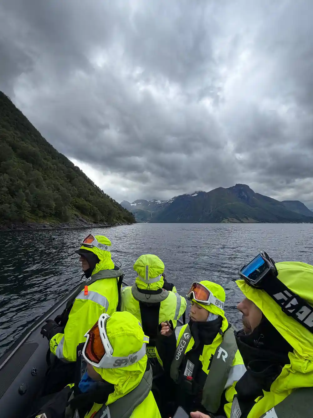 Group of people in yellow gear in inflatable boat
