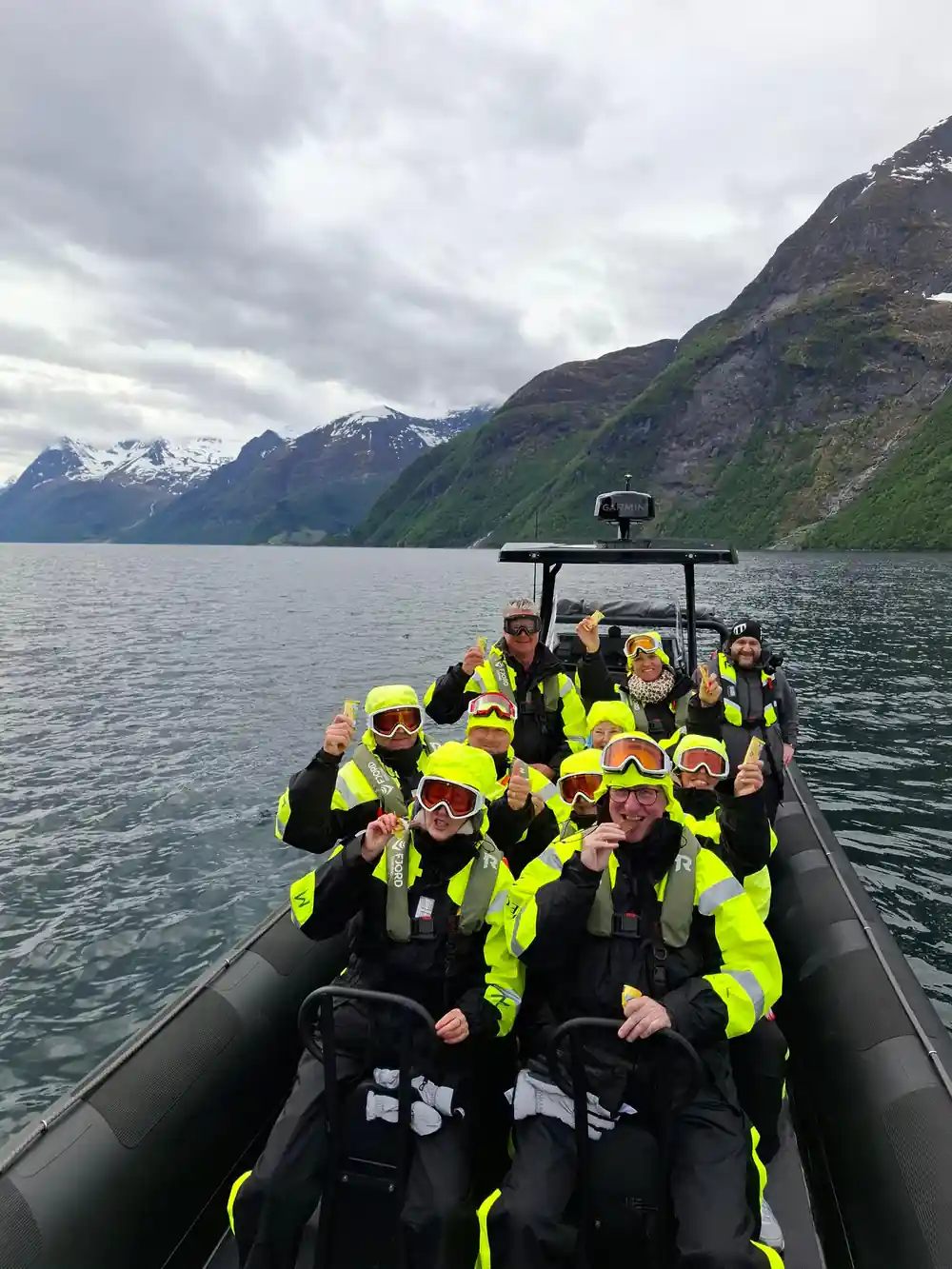 Group in yellow lifejackets on speedboat deck